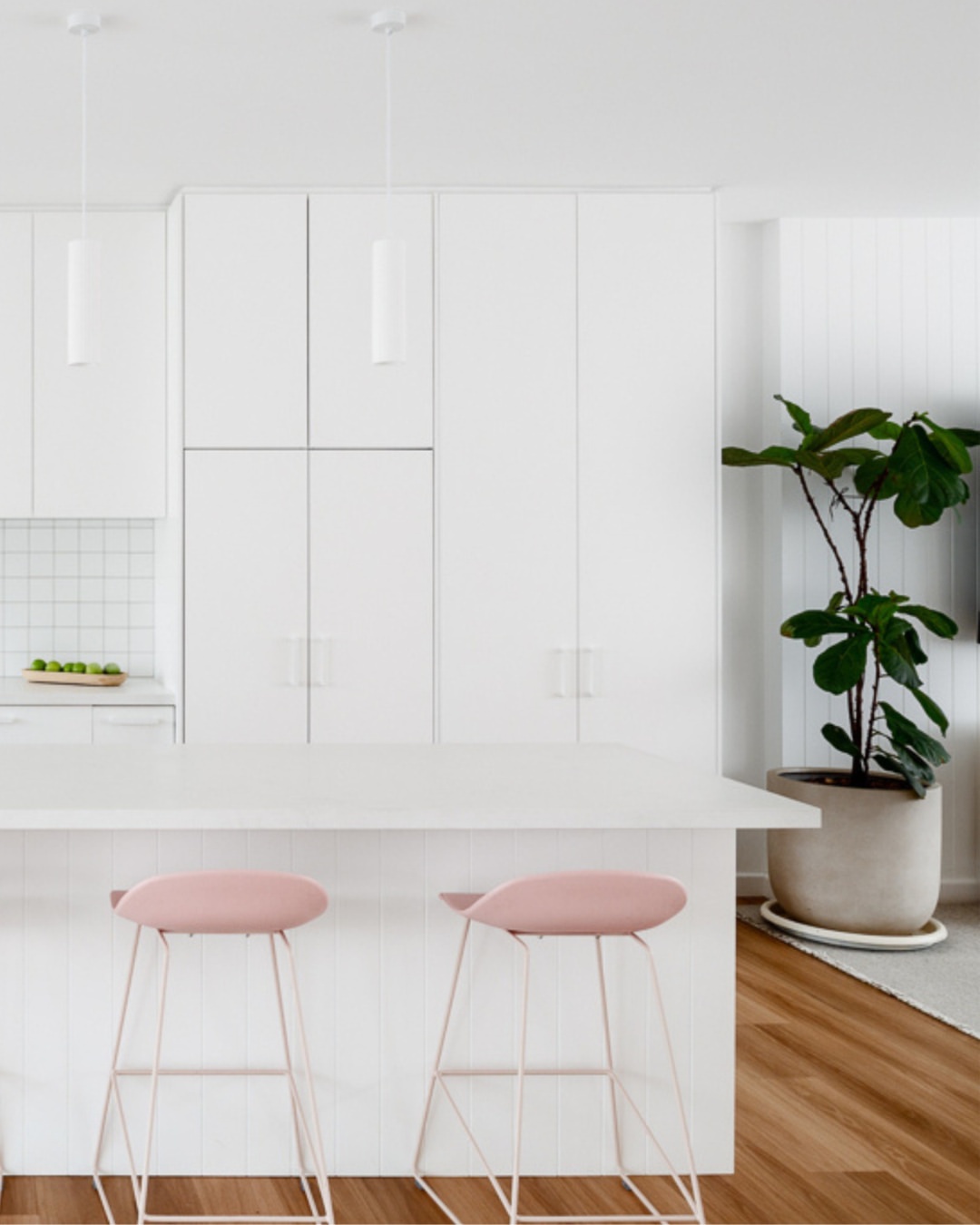 Bright, open-plan kitchen interior of a completed CKS Projects custom home in the Illawarra, showing high-gloss cabinetry, pendant lighting, timber floors, and a large island bench, representing the quality outcome that reaches Occupation Certificate stage