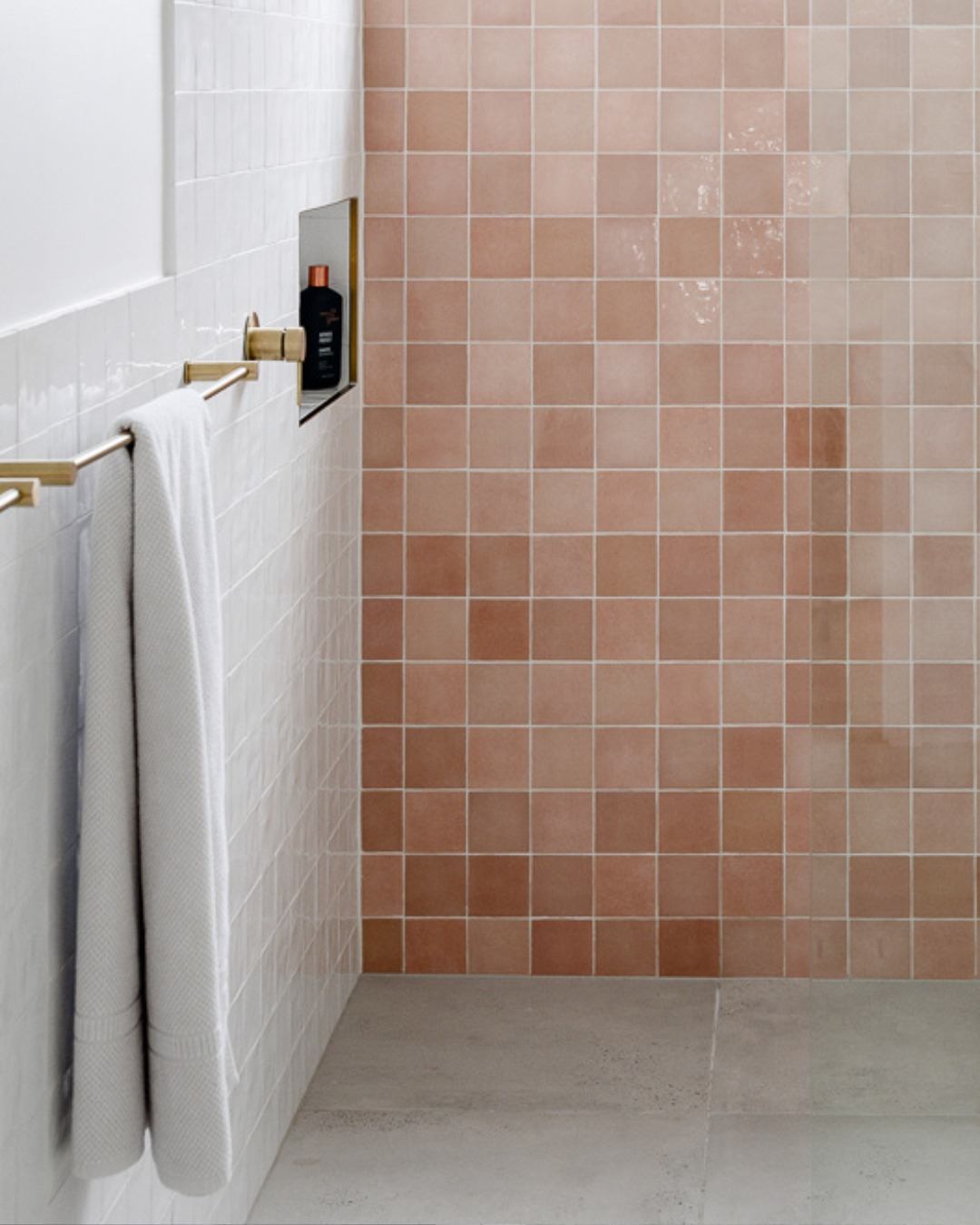 Bathroom detail showing blush zellige tiles with brass towel rail and hardware — an example of curated material selections working together